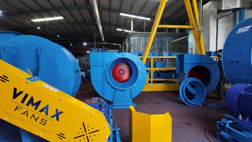 Industrial setting with colorful equipment and machinery components.