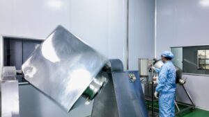 A person operates machinery in a clean industrial environment.